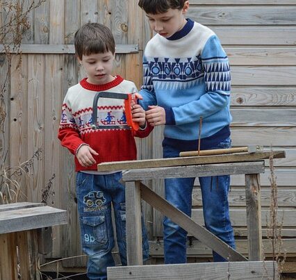 Brother helping Brother with a saw