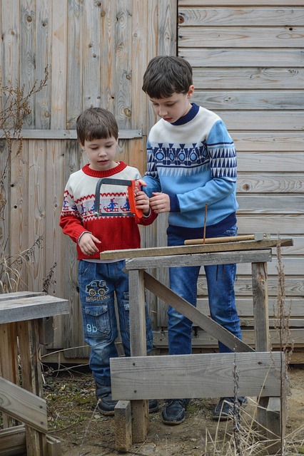 Brother helping Brother with a saw