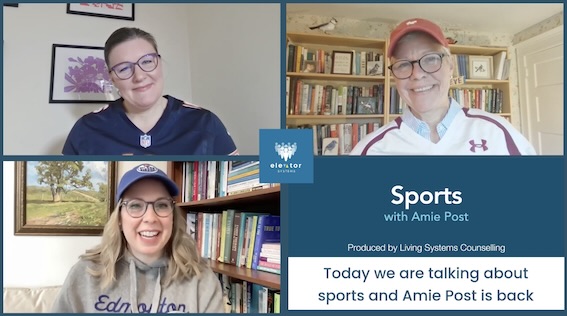 Man sitting with hands on face, blinds behind, decorative items in view